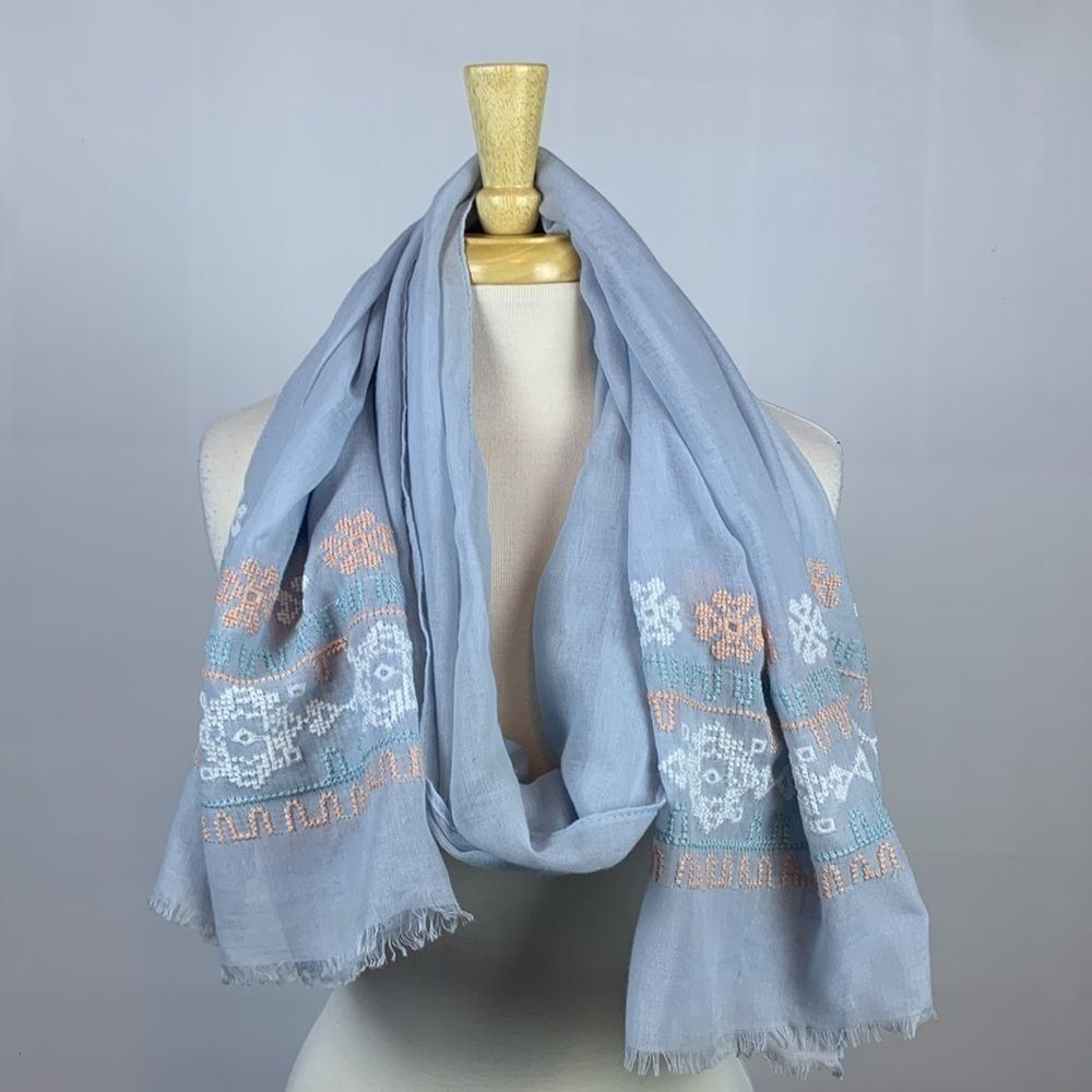 Light blue with light blue, peach, and white embroidered scarf or wrap